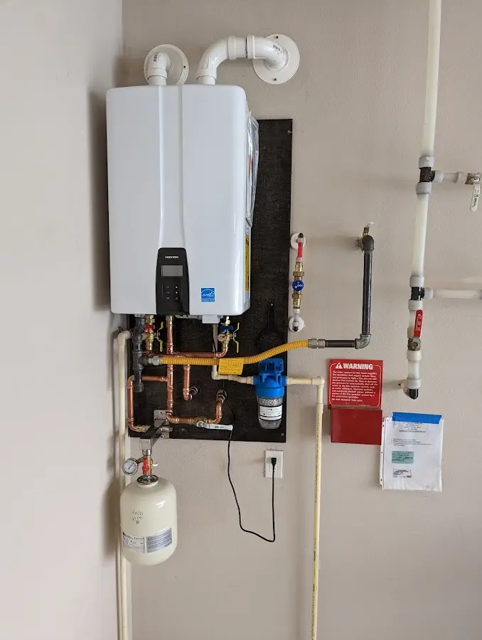 Professional plumber installing copper piping in a Kula home